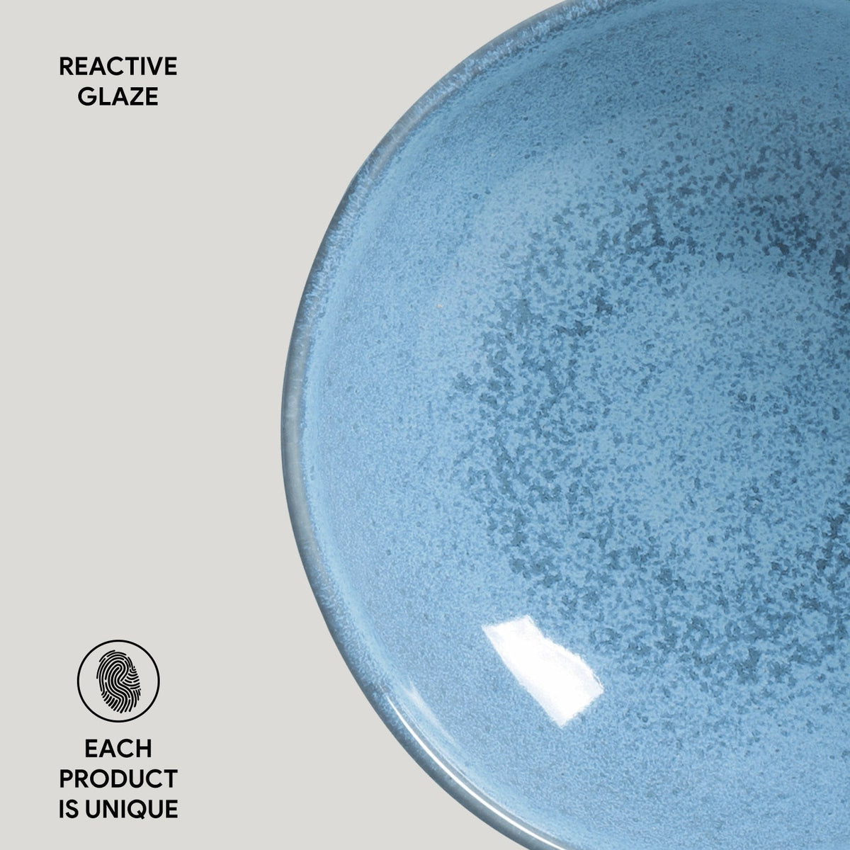 Blue ceramic plate with reactive glaze on a light gray background