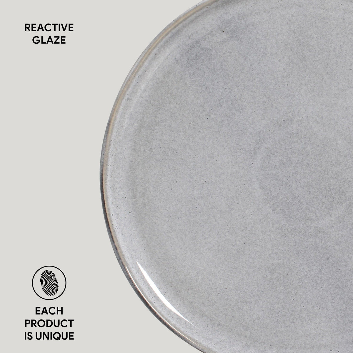 Close-up of a gray ceramic plate with 'Reactive Glaze' text and 'Each Product is Unique' label.