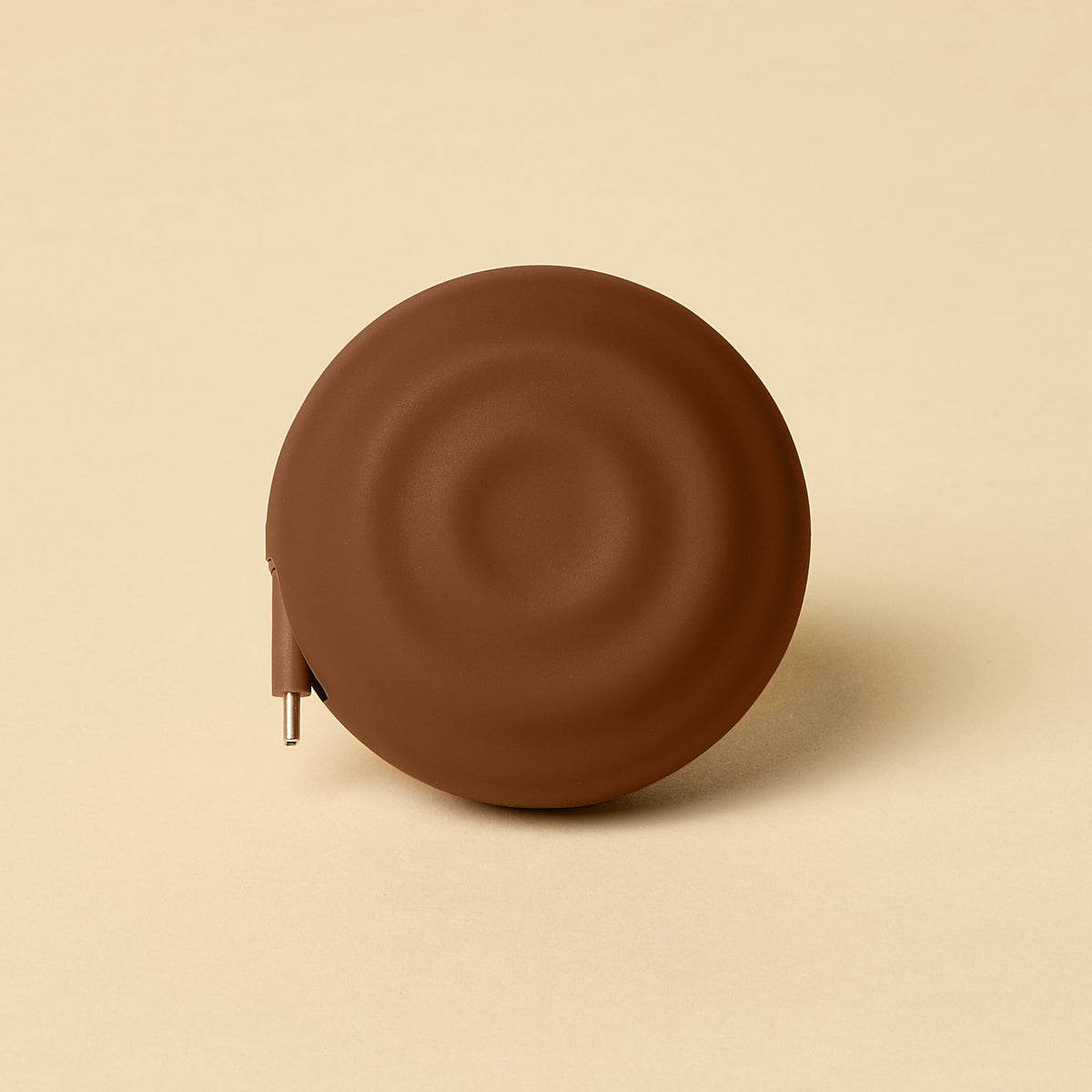 Brown circular object on a beige background