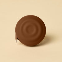 Brown circular object on a beige background