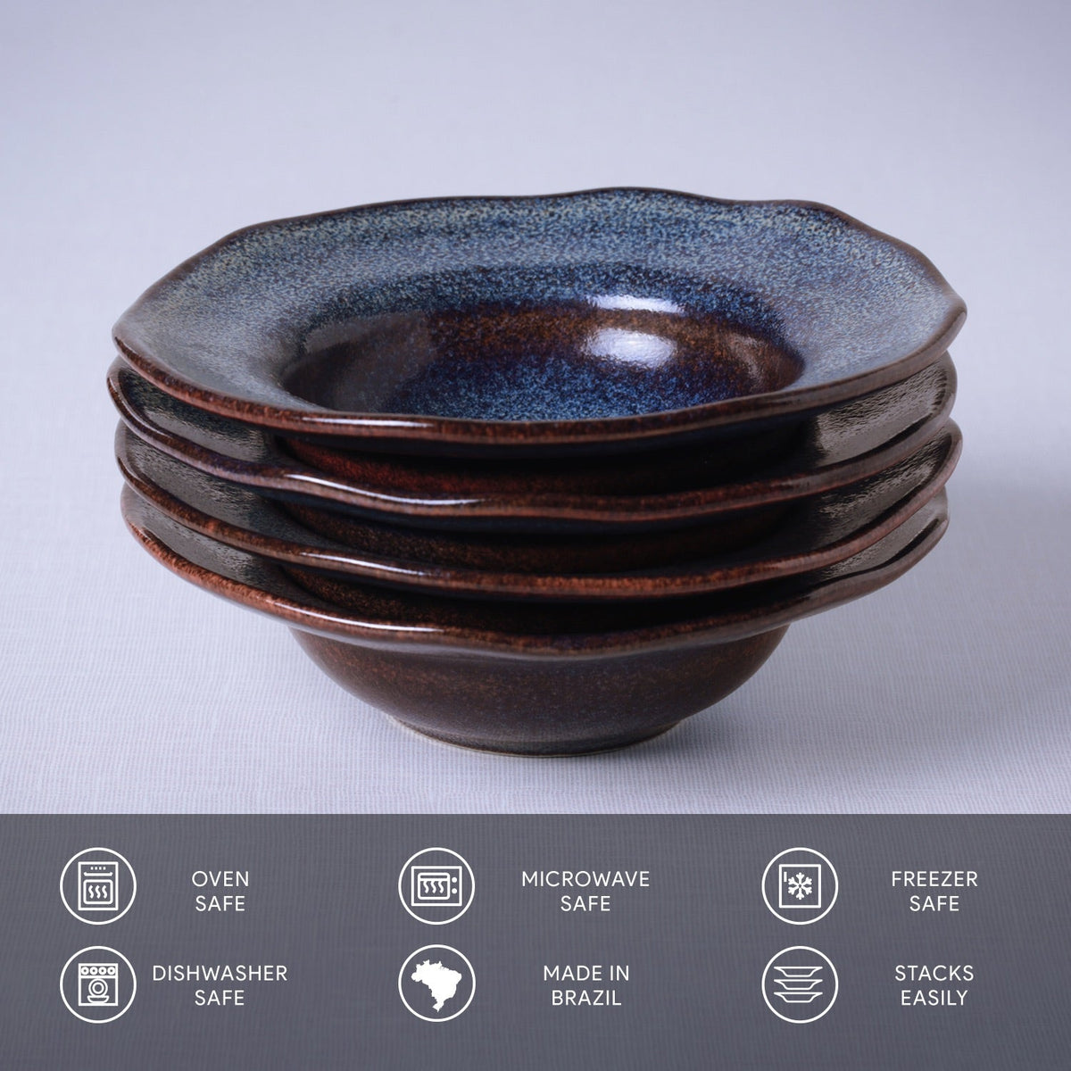 Stack of ceramic bowls with blue speckled top and brown base on a light gray background.