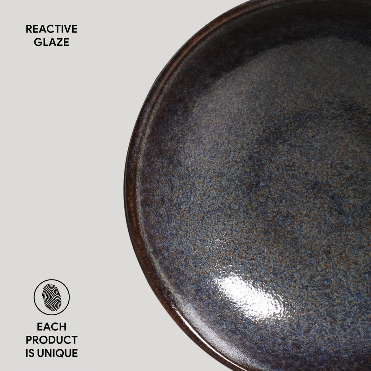 Ceramic bowl with reactive glaze on a light gray background