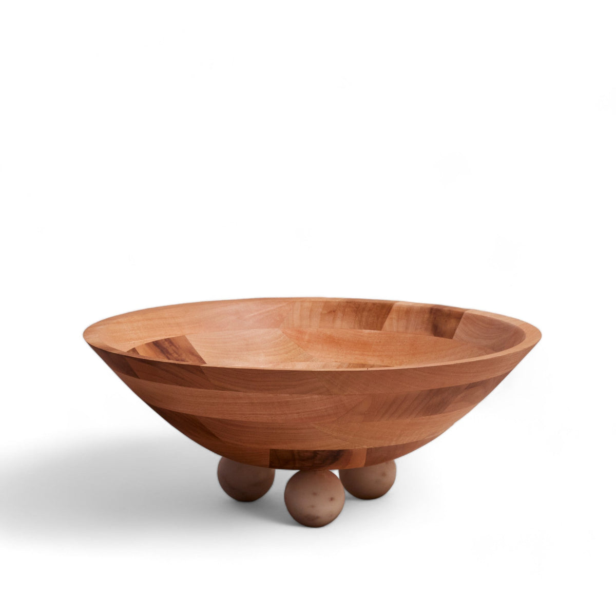 Wooden bowl with three spherical marble feet on a white background