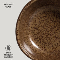 Brown ceramic plate with reactive glaze on a light gray background