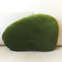 Green cushion on a beige sofa