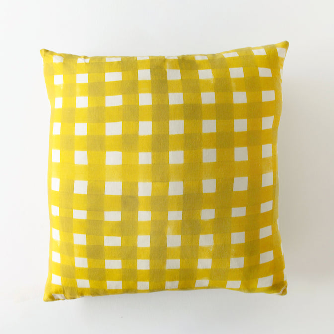 Yellow checkered pillow on a white background