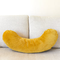 Yellow slim pillow on a beige sofa