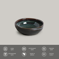 Ceramic bowl with greenish-brown glaze on a gray background