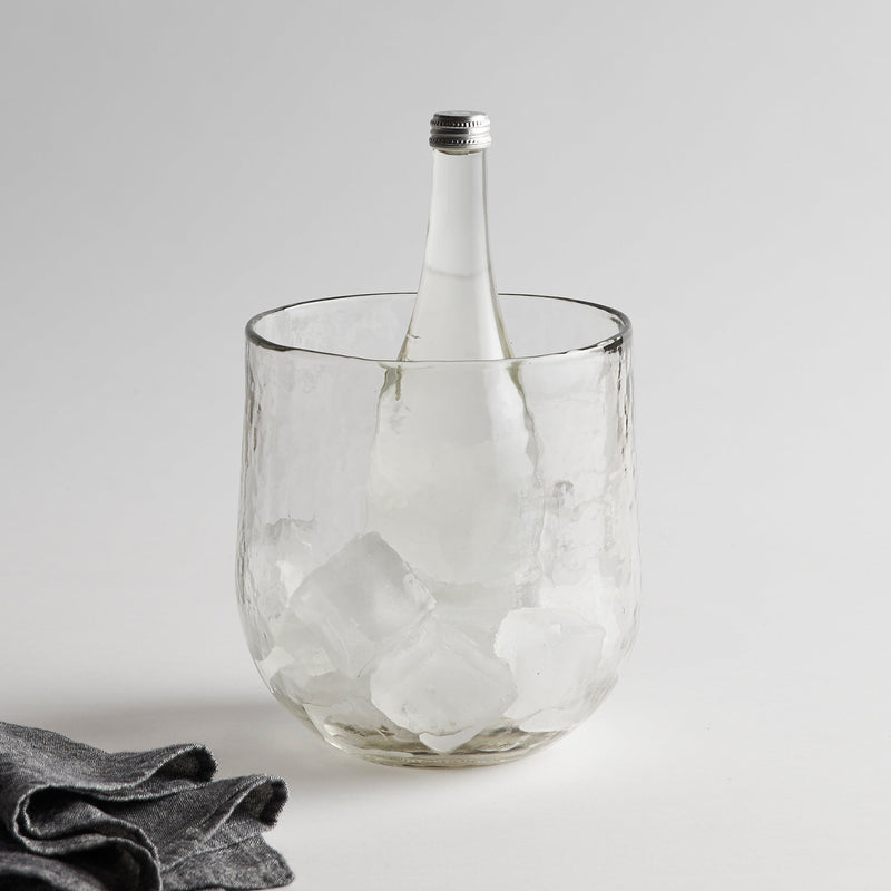Clear glass ice bucket with bottle on a white background