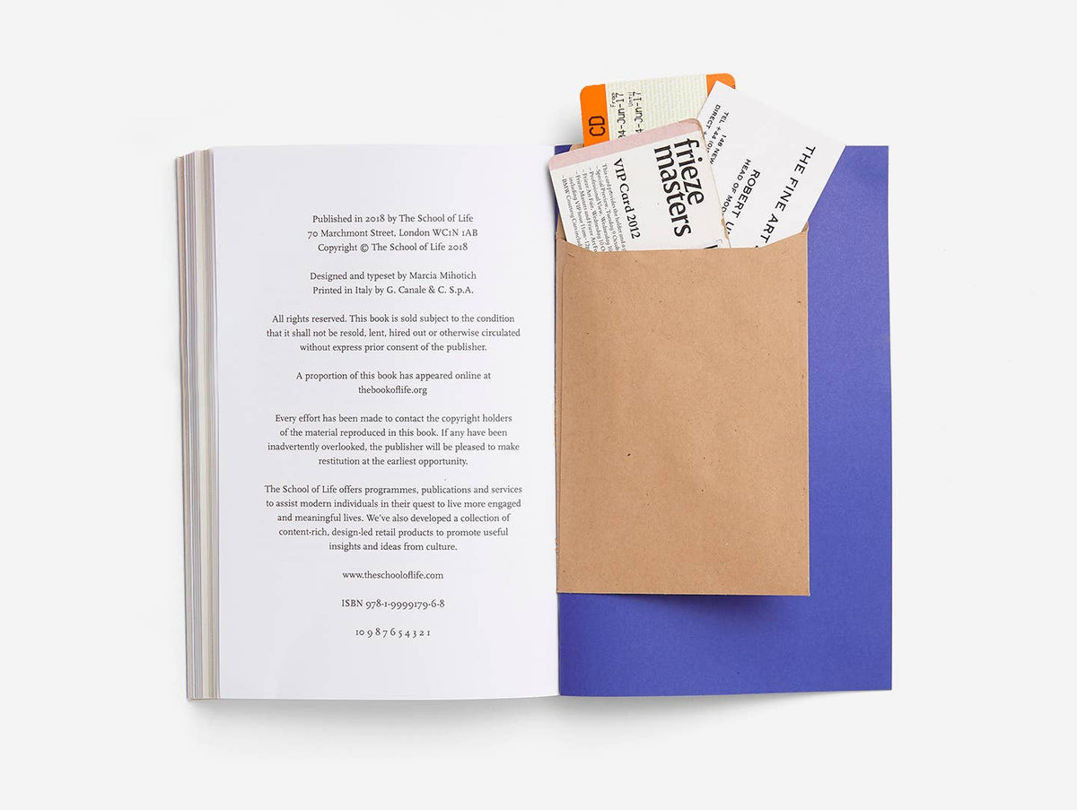 Open book with a brown envelope and colorful paper on a white background