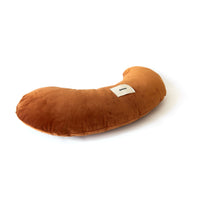 Brown U-shaped pillow on a white background