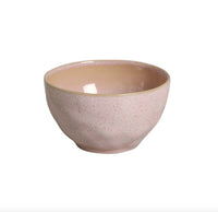 Ceramic bowl with speckled beige and pink design on a white background
