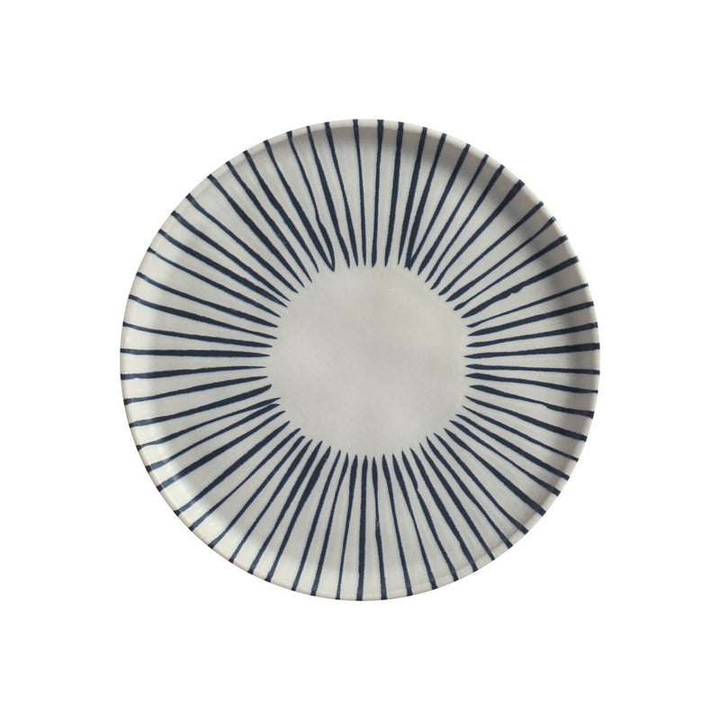 Ceramic plate with blue radial pattern on a white background
