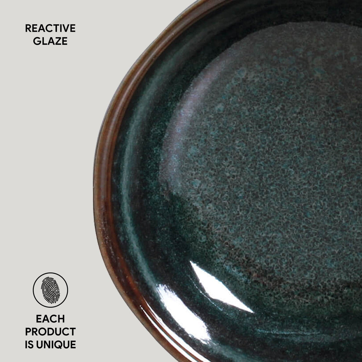 Close-up of a ceramic bowl with reactive glaze on a light gray background