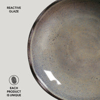 Ceramic plate with reactive glaze on a light gray background