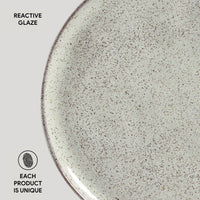 Close-up of a ceramic plate with reactive glaze texture on a white background