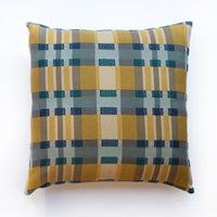 Plaid patterned pillow with yellow and blue colors on a white background