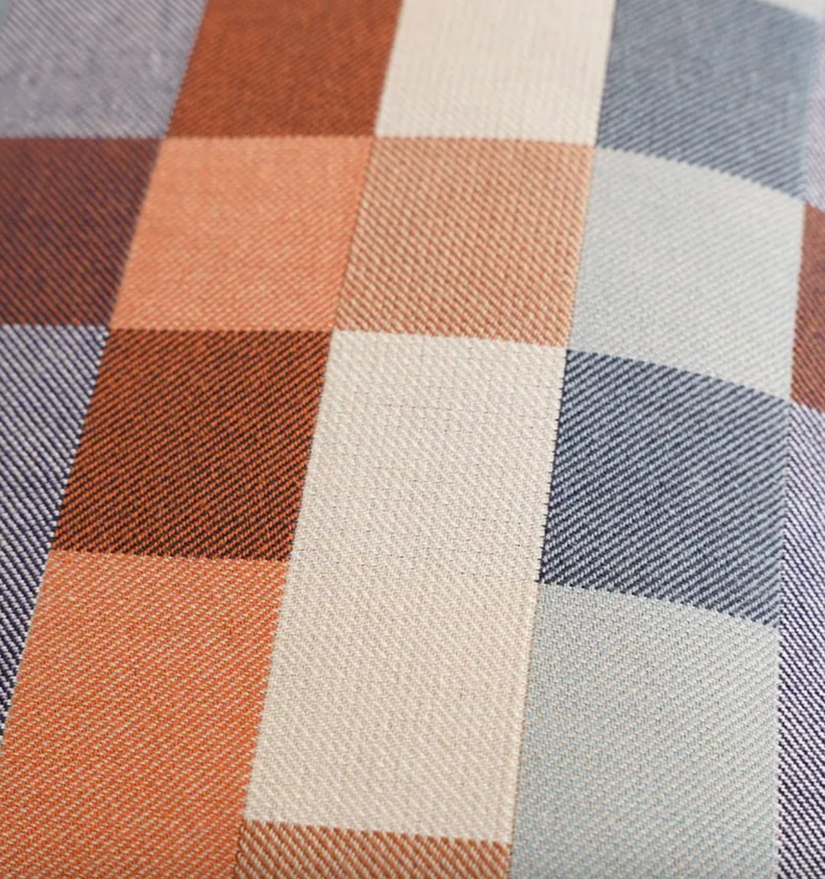 Close-up of a checkered fabric with brown, beige, and blue squares.