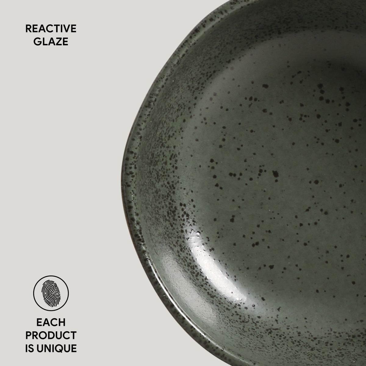 Close-up of a ceramic plate with reactive glaze on a light gray background