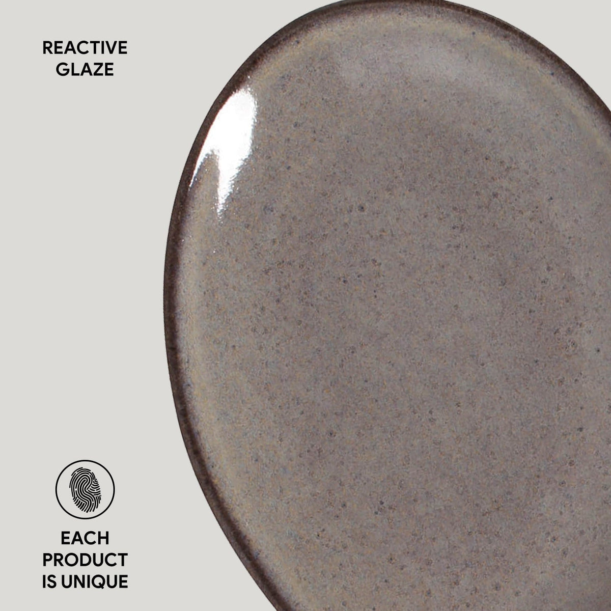 Close-up of a ceramic plate with reactive glaze on a light gray background