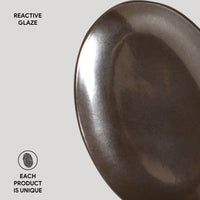 Dark metallic ceramic plate with 'Reactive Glaze' text on a light gray background
