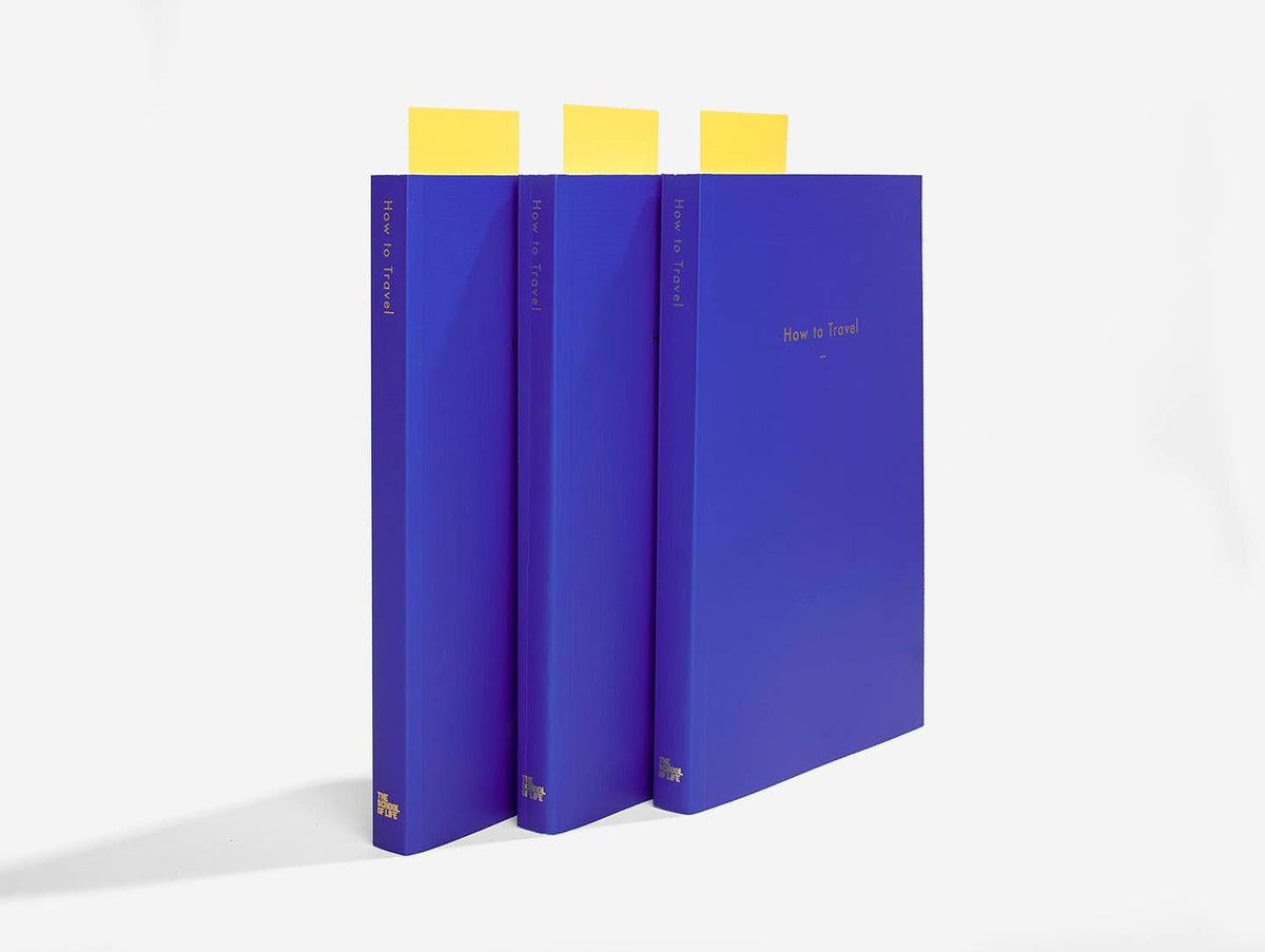 Three blue books with yellow bookmarks on a white background