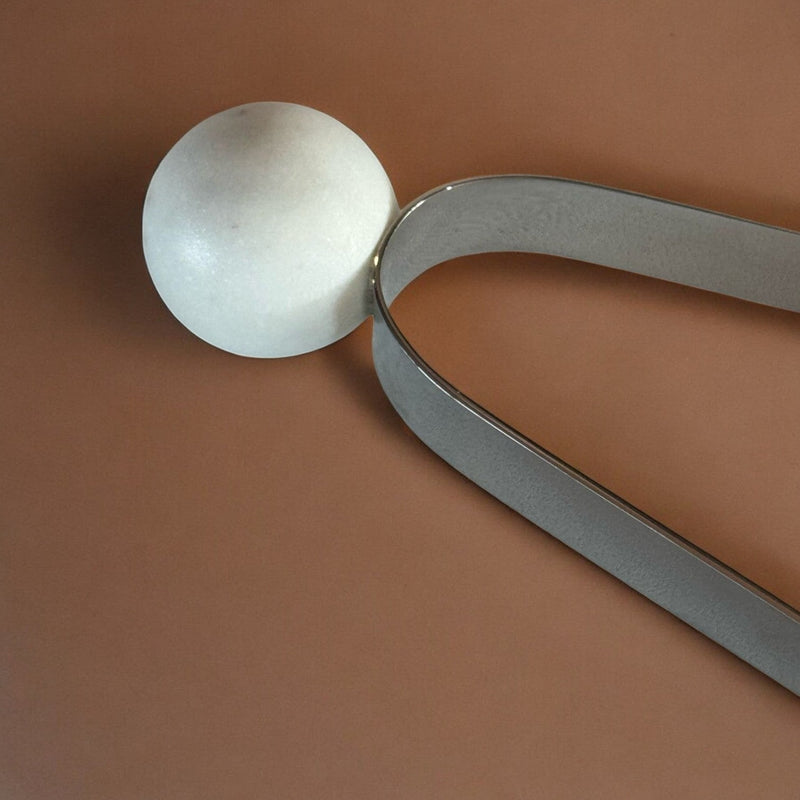 Marble sphere accent on tongs