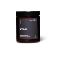 Dark glass jar scented soy wax candle with lid and branded label reading Earl of East Onsen