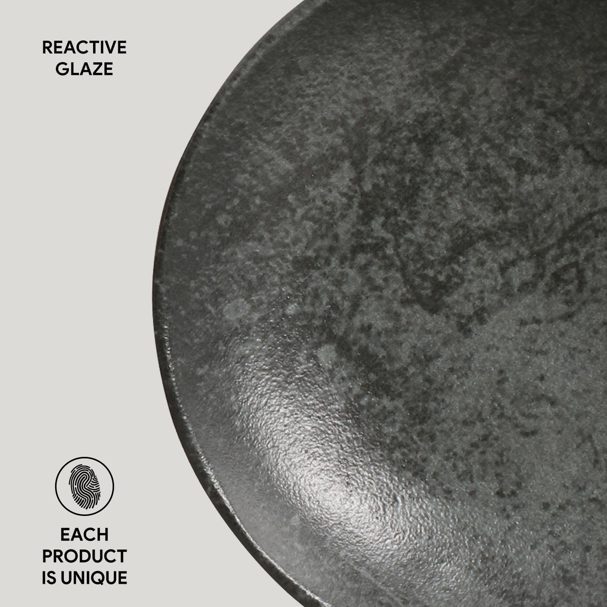 Close-up of a ceramic bowl with reactive glaze on a light gray background