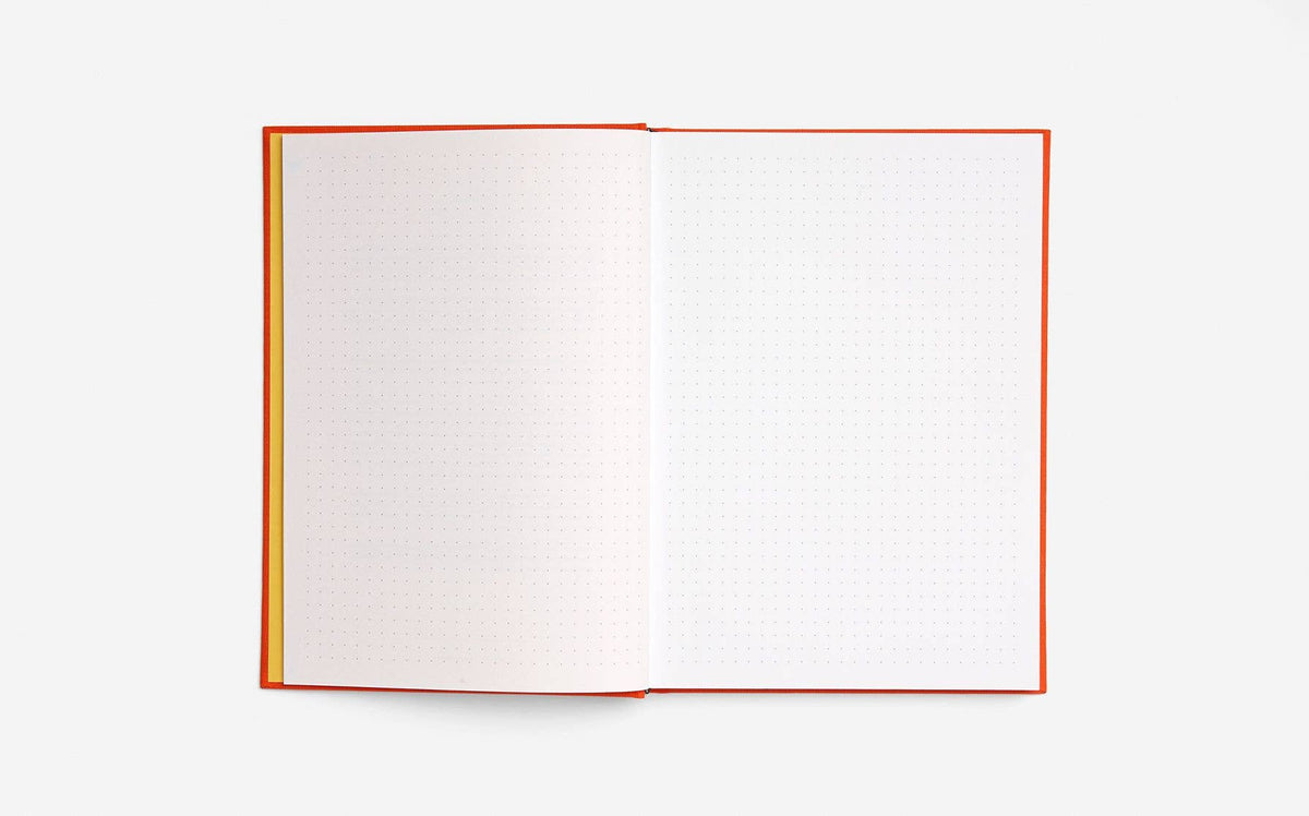 Open book with red binding and dotted pages on a white background