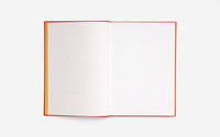Open book with red binding and dotted pages on a white background