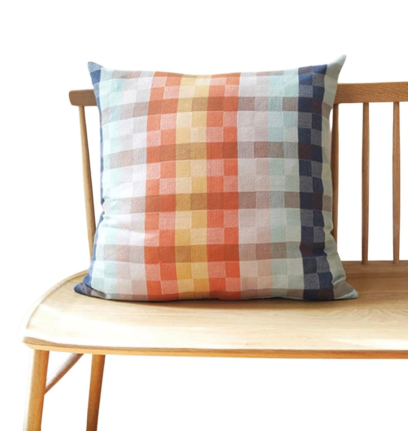 Checkered pillow on a wooden chair with a white background