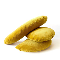 Stack of yellow velvet pillows on a white background