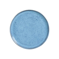Blue ceramic plate with a speckled texture on a white background