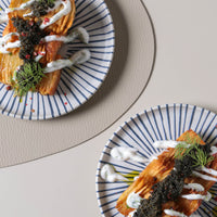 Two plates of food with decorative elements on a light background