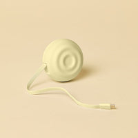 Light yellow electronic charging device with a cable on a beige background