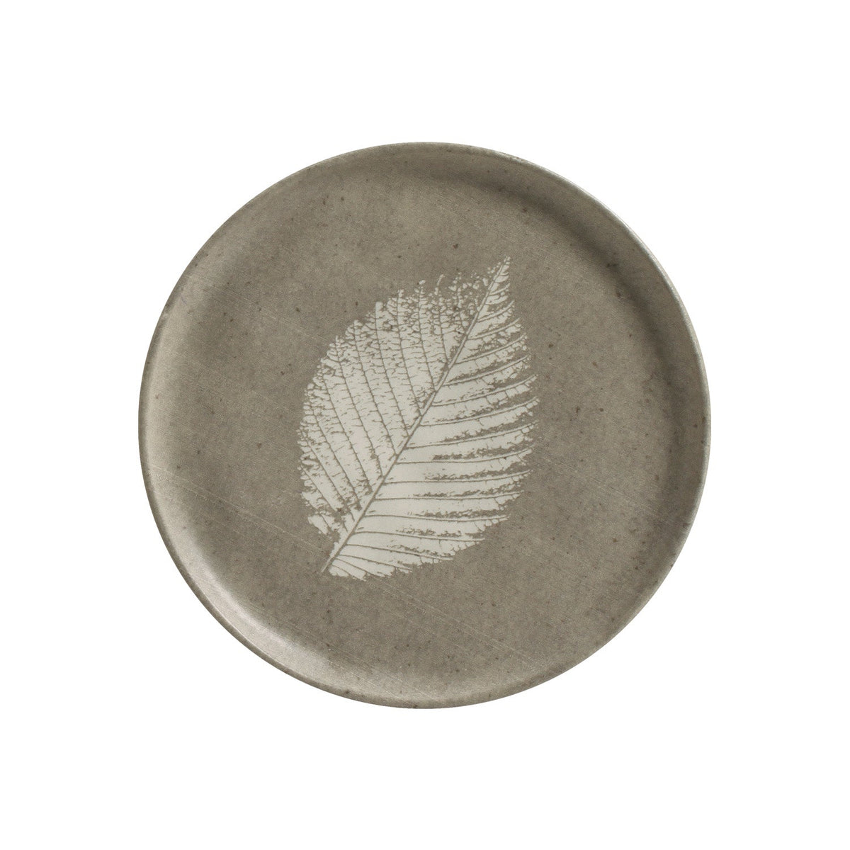 Round ceramic plate with a leaf design on a white background