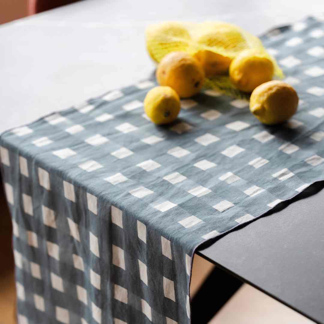 Checkered table runner with lemons on a table