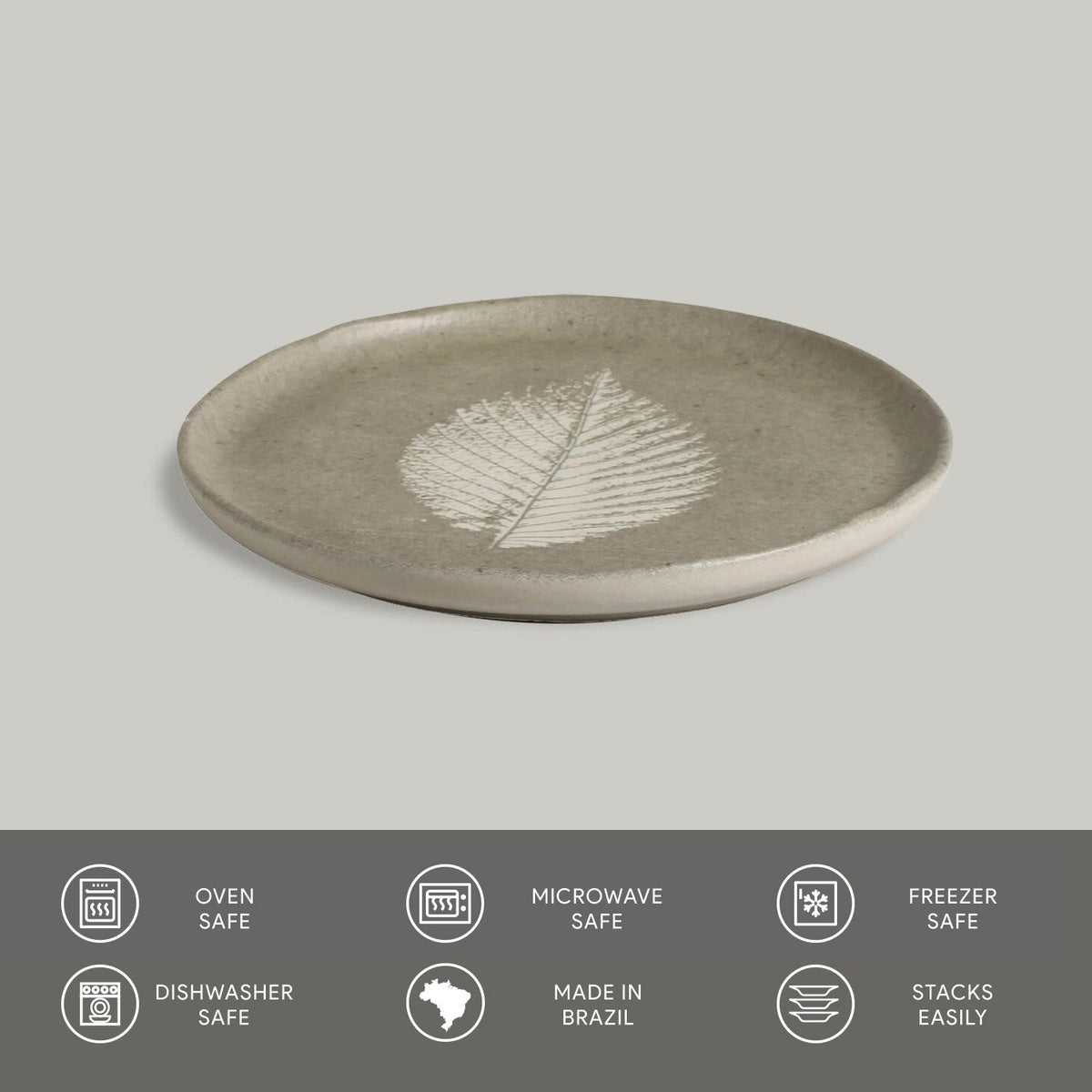 Ceramic plate with leaf design on a gray background