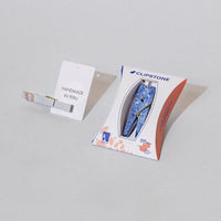 a blue stone clothespin in packaging next to a notecard that says 'Handmade in Peru'