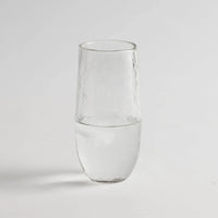 Tall drinking glass with water on a white background