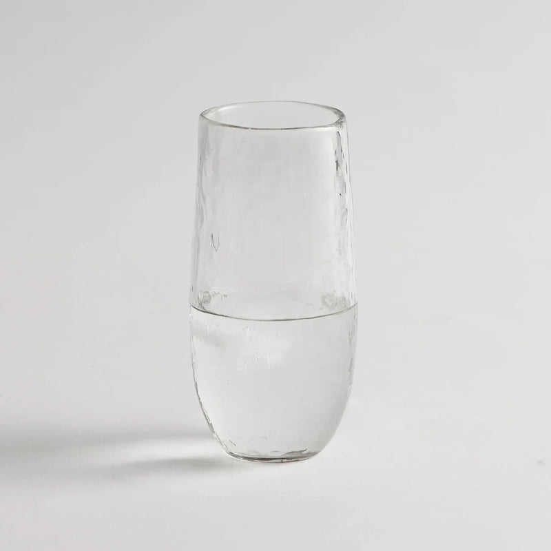 Tall drinking glass with water on a white background