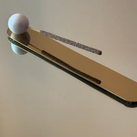 Gold incense holder with a white marble ball 