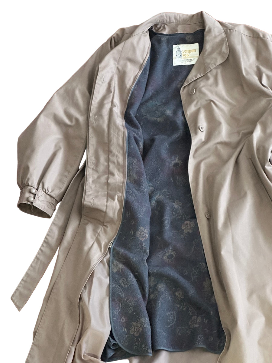 Taupe trench coat with pattern lining on a white background