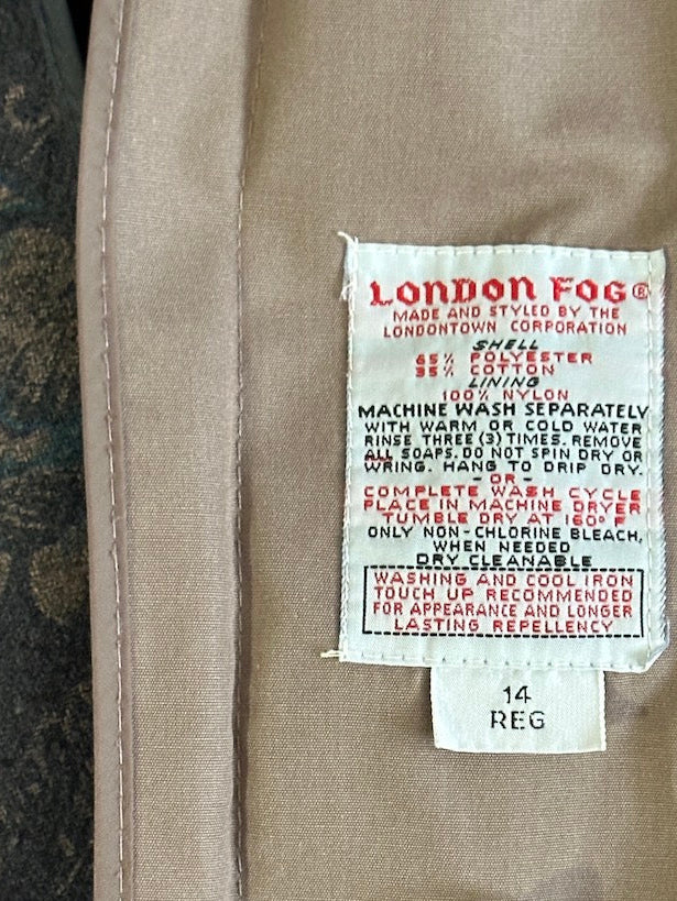 Close-up of a London Fog label on a taupe jacket.