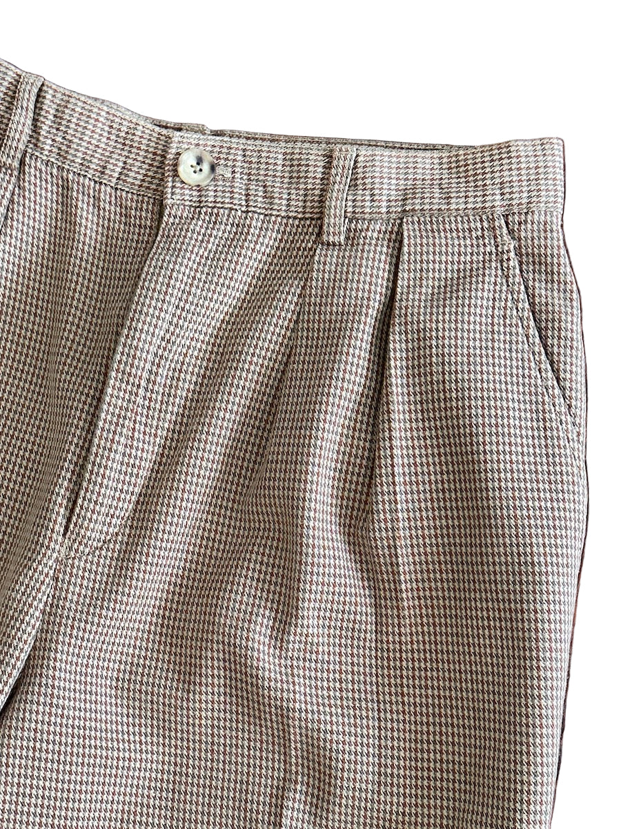 Houndstooth patterned pants close up on a white background