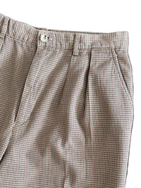 Houndstooth patterned pants close up on a white background