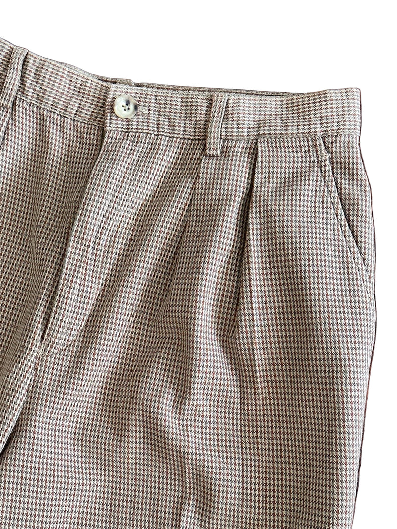 Houndstooth patterned pants close up on a white background