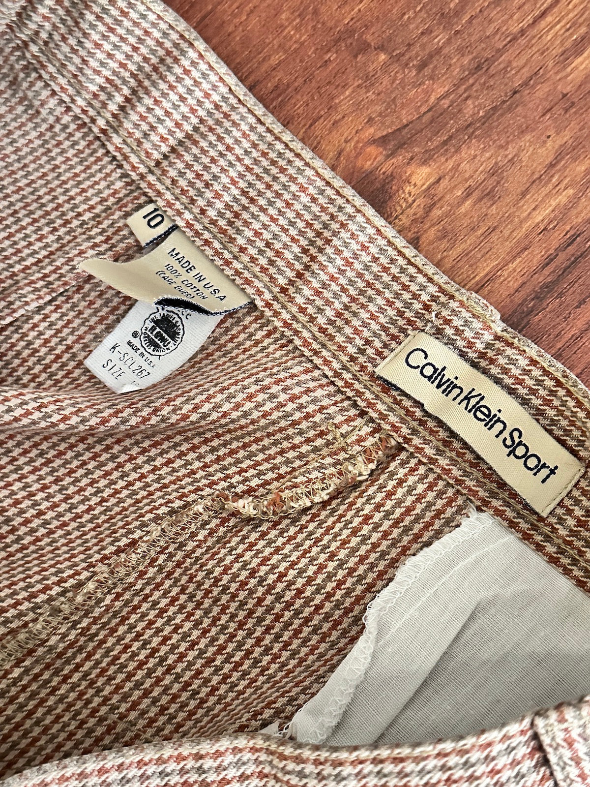 Close-up of a Calvin Klein Sport label and Union made label on a pair of trousers