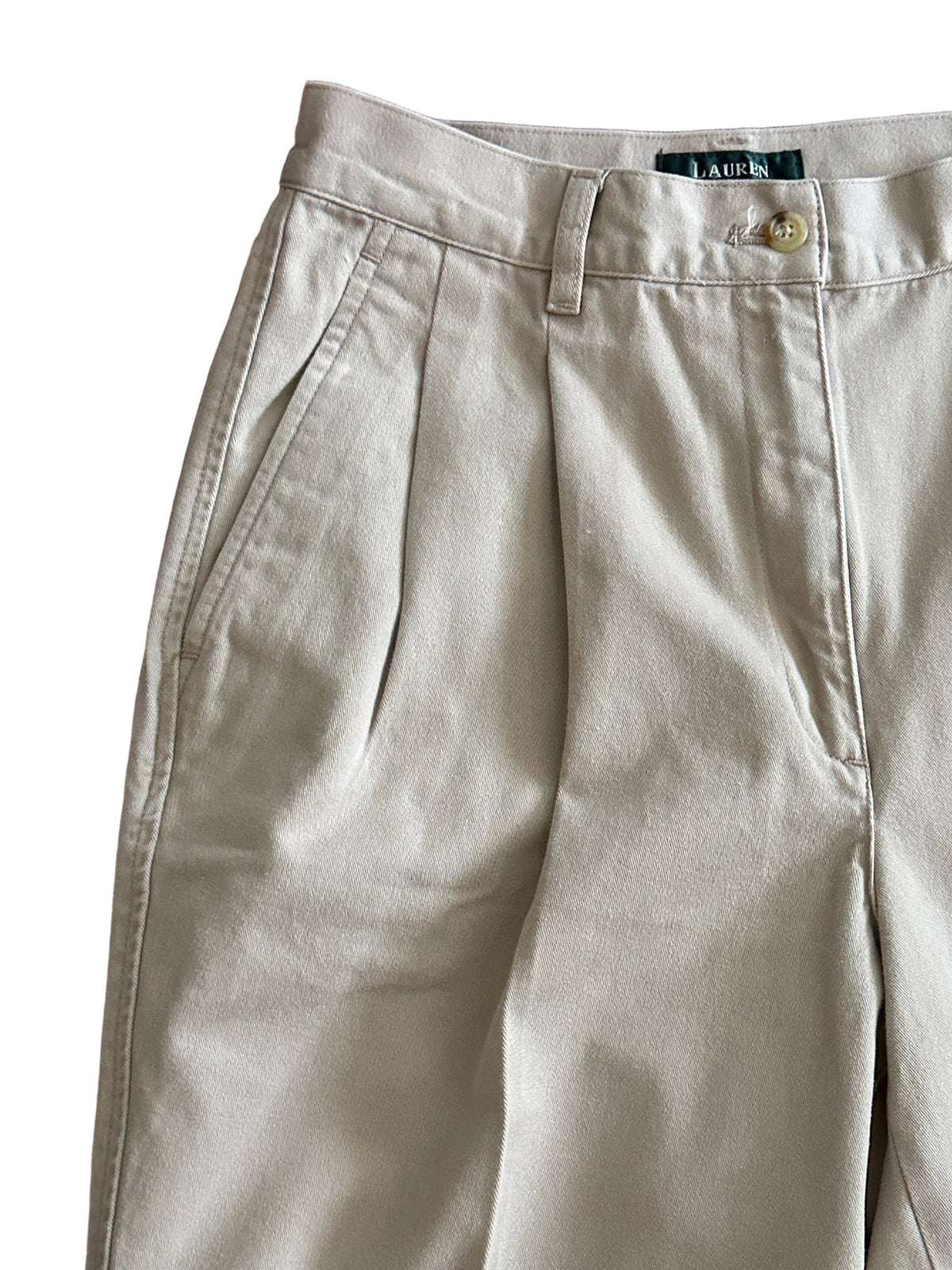 Close up of beige pants on a white background